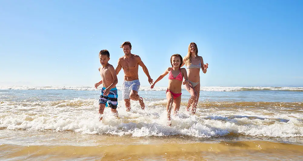 Family having fun in the water at the beach