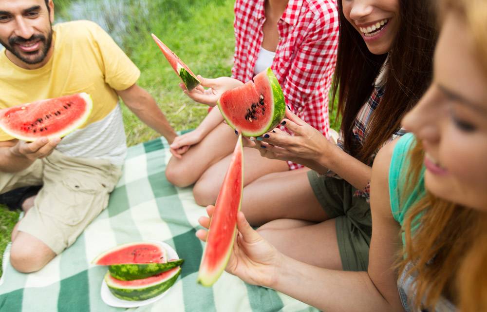 Group of friends eating watermelon